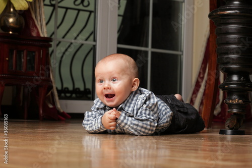 6 months male child sitting on floor