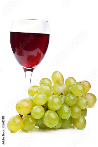 one glass of wine and grapes
