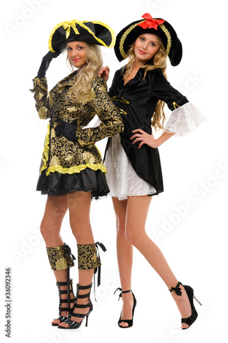 Two beautiful women in carnival costumes. Pirate and empress sha