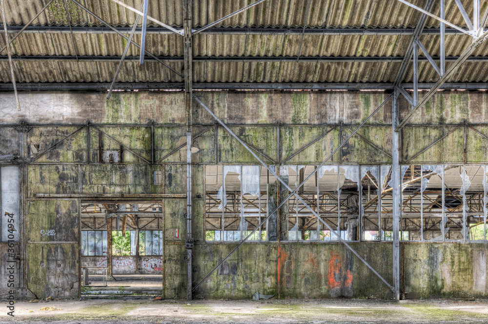 Fototapeta premium Derelict interior of dilapidated warehouse