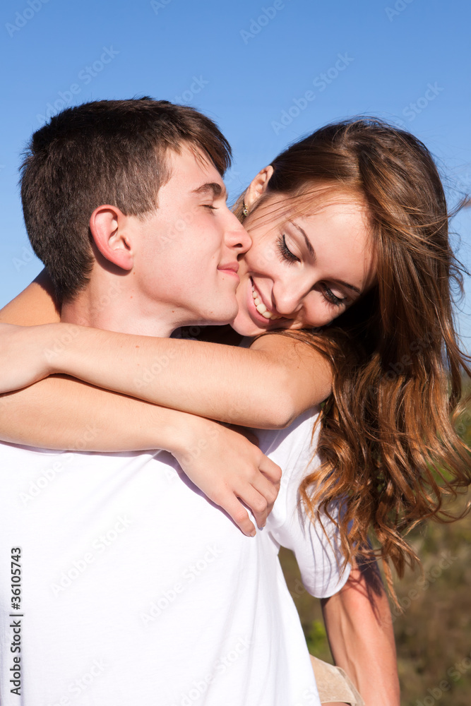 Love and affection between a young couple at the park Love and affection between a young couple at the park