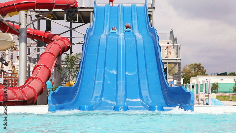 Sliding down on water slide in waterpark