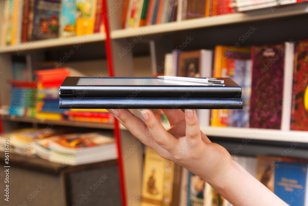 Hand holds electronic book reader