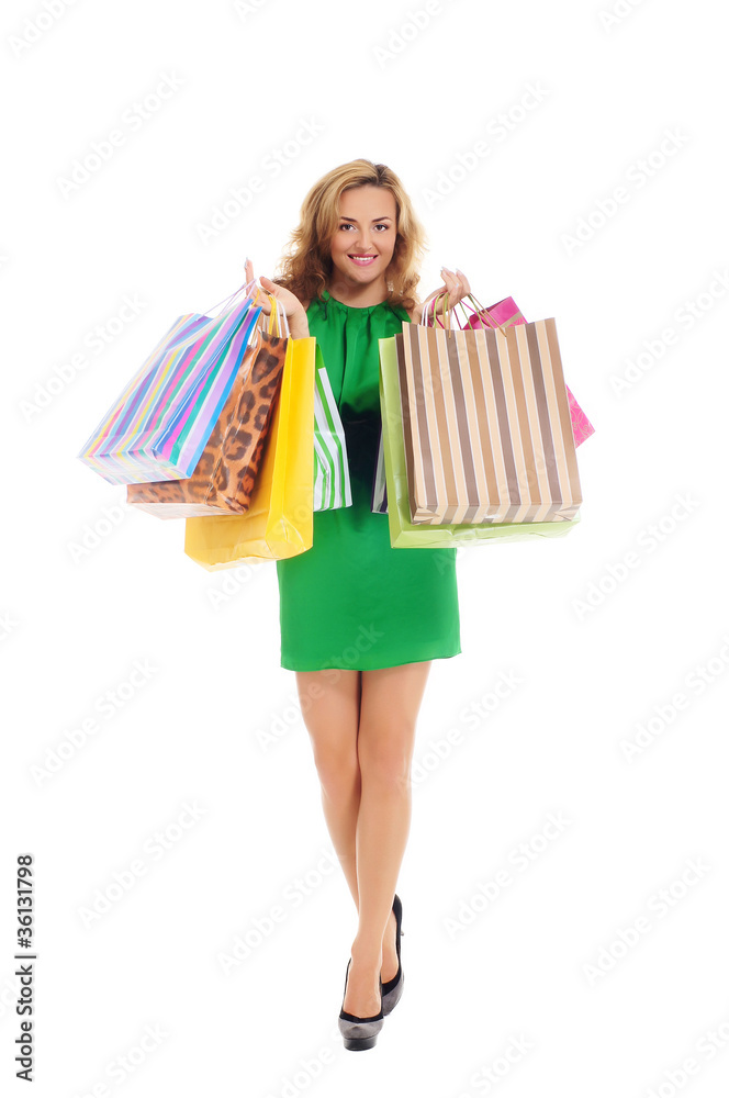 A young woman in a green dress with shopping bags