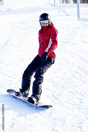 Female snowboarder on the snowhill