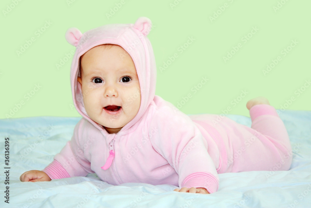 Smiling baby girl wearing pink teddy costume Smiling baby girl wearing pink teddy costume