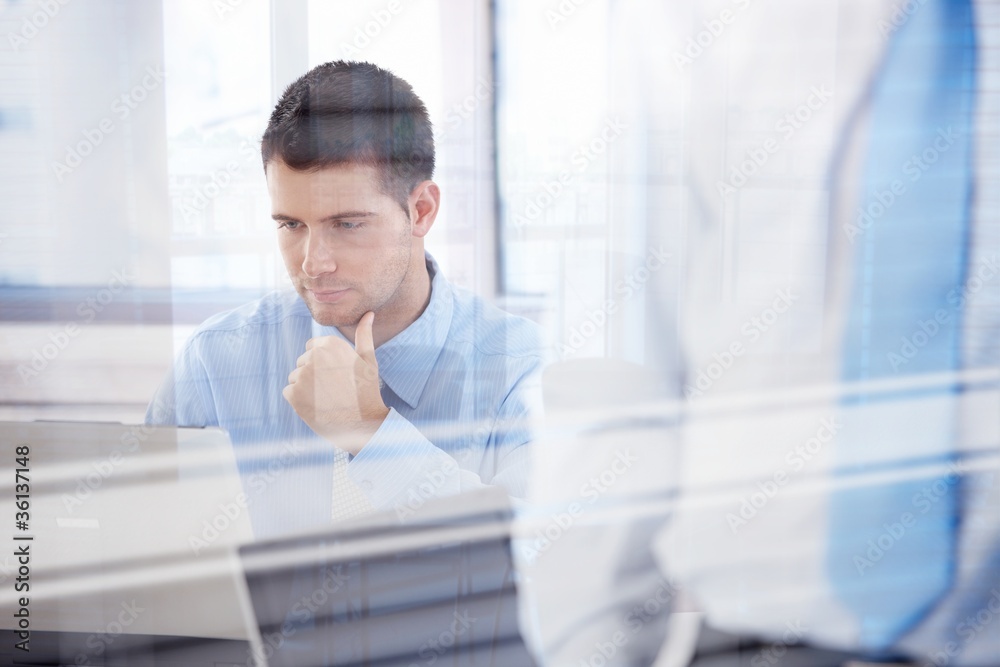 Young businessman working in bright office Young businessman working in bright office