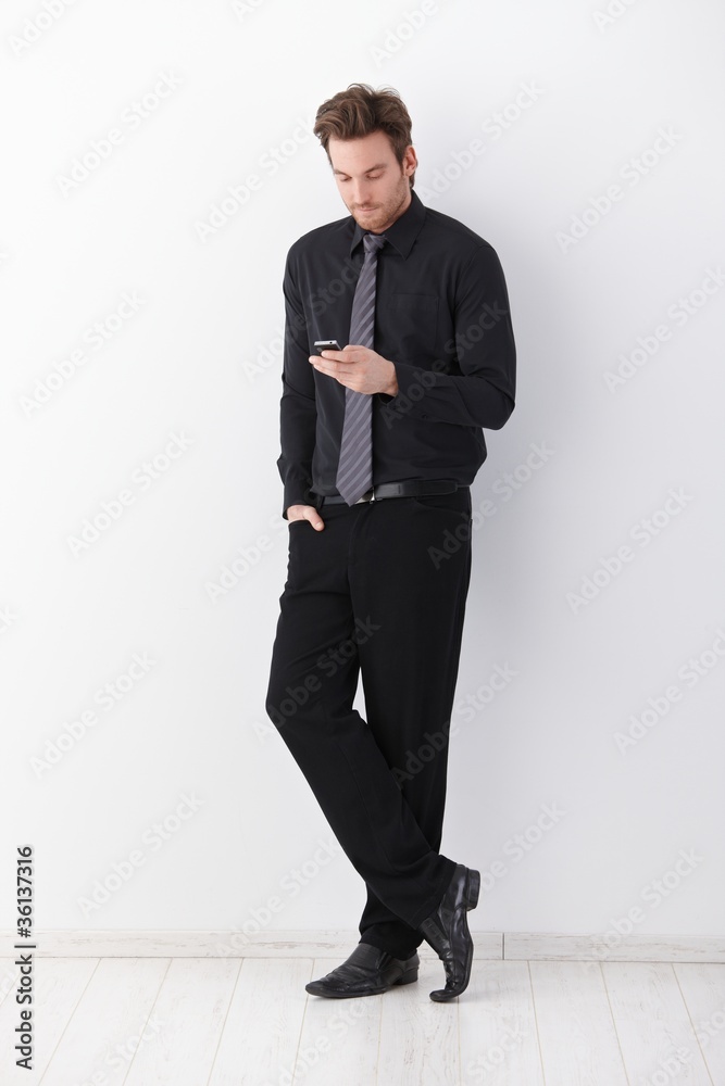 Stylish businessman writing text message Stylish businessman writing text message