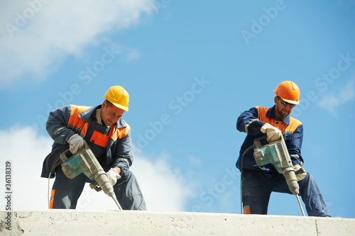 construction workers with perforator