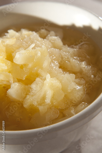 Crushed pineapple in a bowl as used in cooking