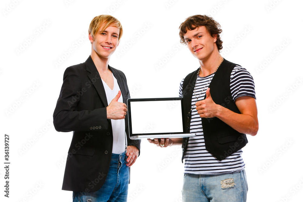 Two happy young men showing laptops blank screen