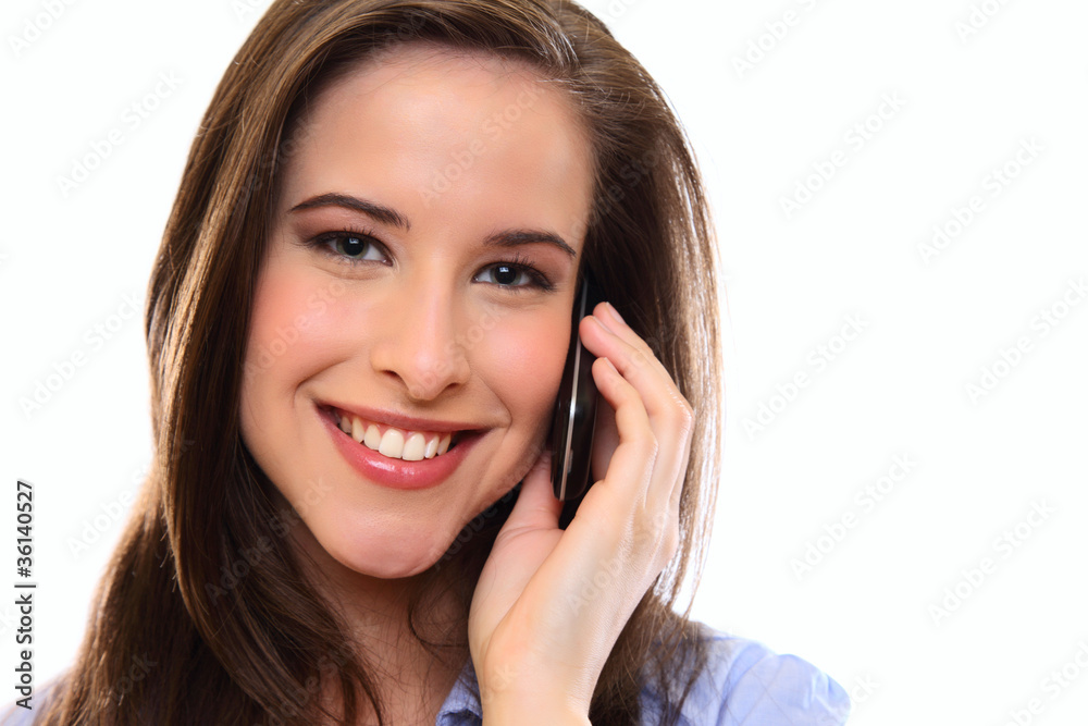 smiling brunette woman using cellphone and looking to the camera smiling brunette woman using cellphone and looking to the camera