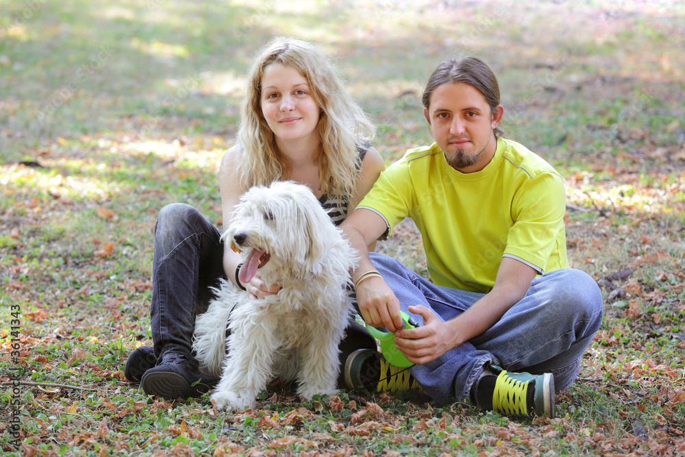 Young people with white dog Young people with white dog