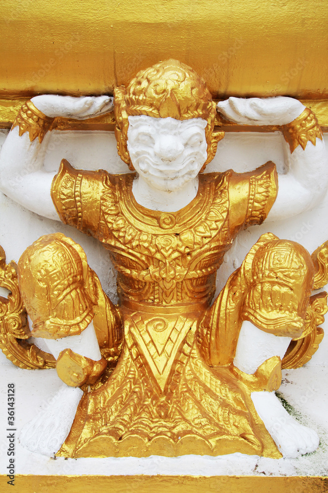 Thai style carving of monkey on the temple wall in Amnatcharoen