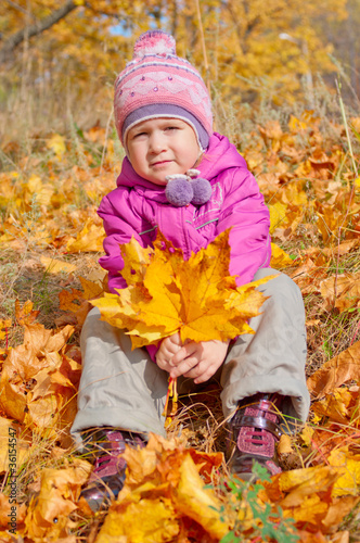 Little girl in autumn forest