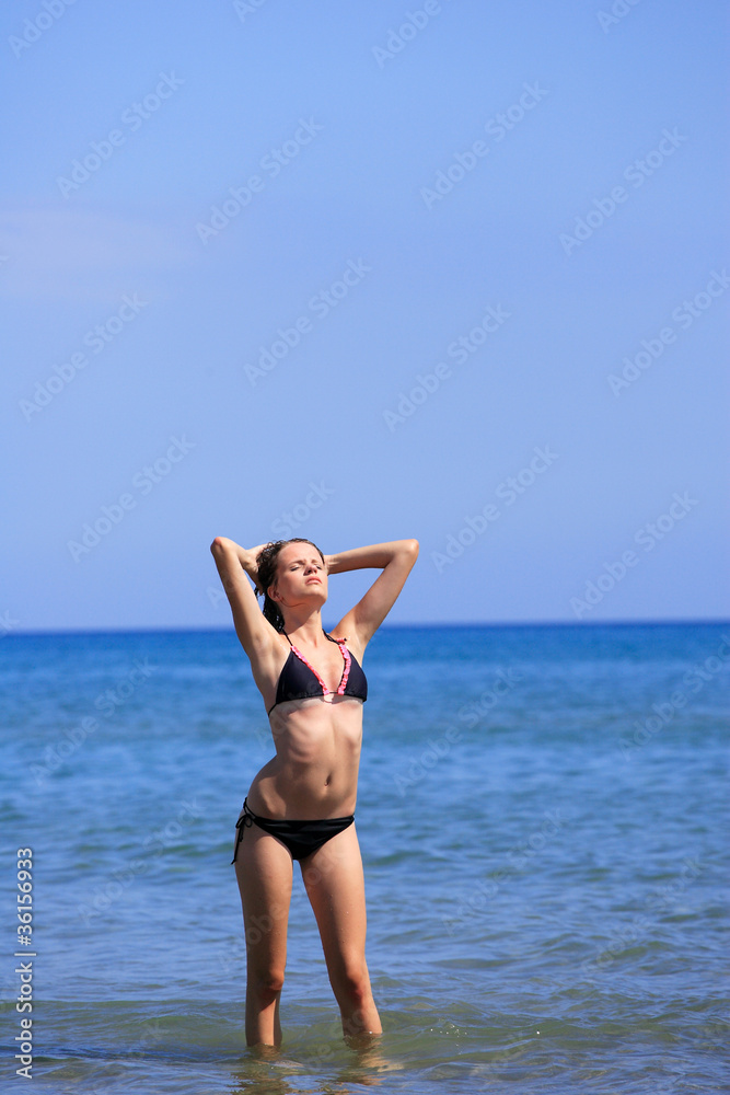 Fototapeta premium Sexy bikini model having fun in the ocean