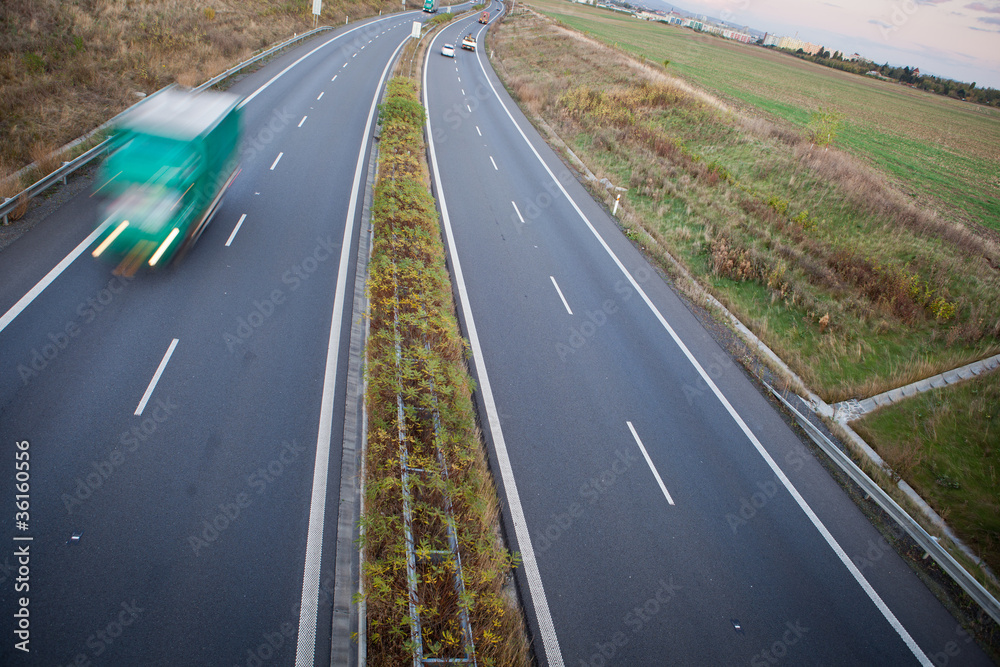 Obraz premium highway traffic - motion blurred truck on a highway