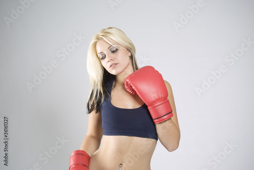 Elegant pose woman boxer with red gloves © StockMasters