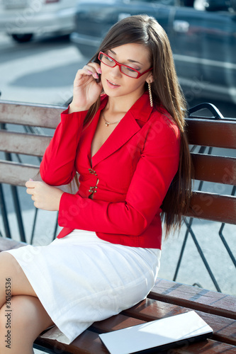 businesswoman calling by phone outdoors