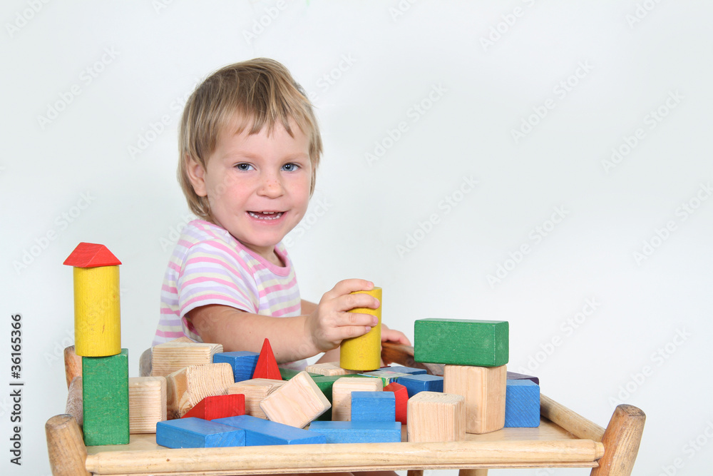 cute child playing with building blocks isolated over white cute child playing with building blocks isolated over white