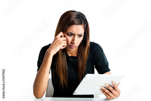Angry young indian teen girl with tablet computer