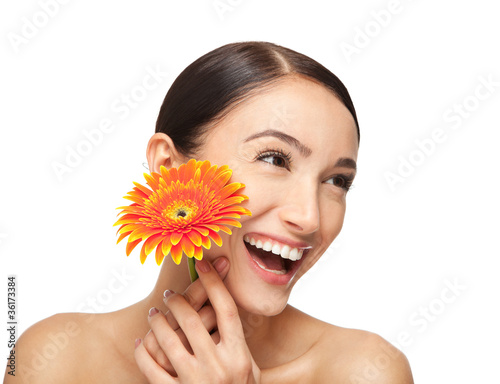 Portrait of beautiful smiling young woman with a flower.