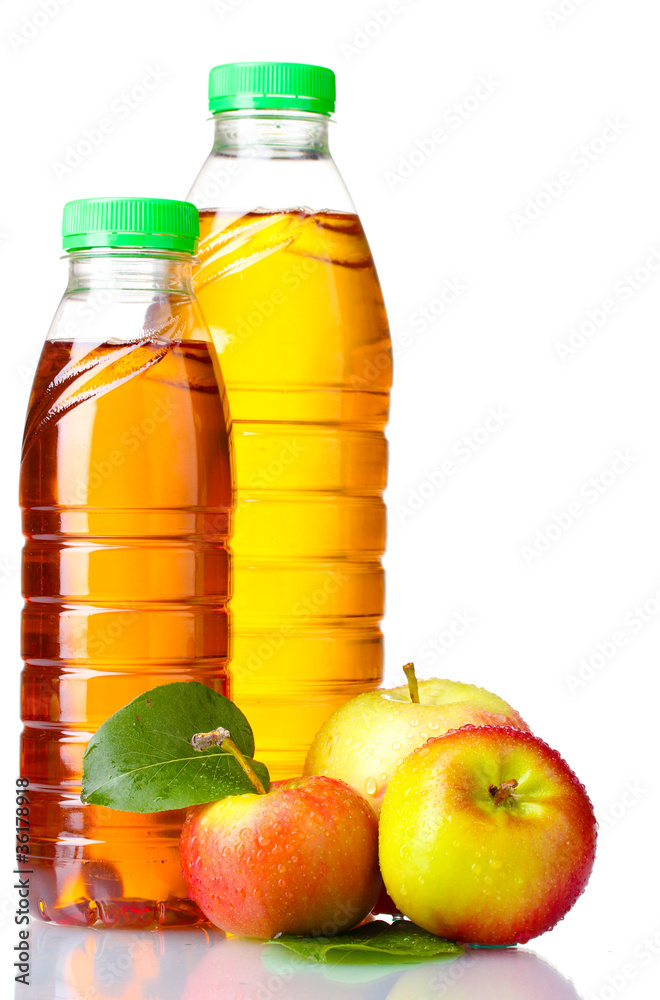 Delicious apple juice in bottles and apples isolated on white Delicious apple juice in bottles and apples isolated on white