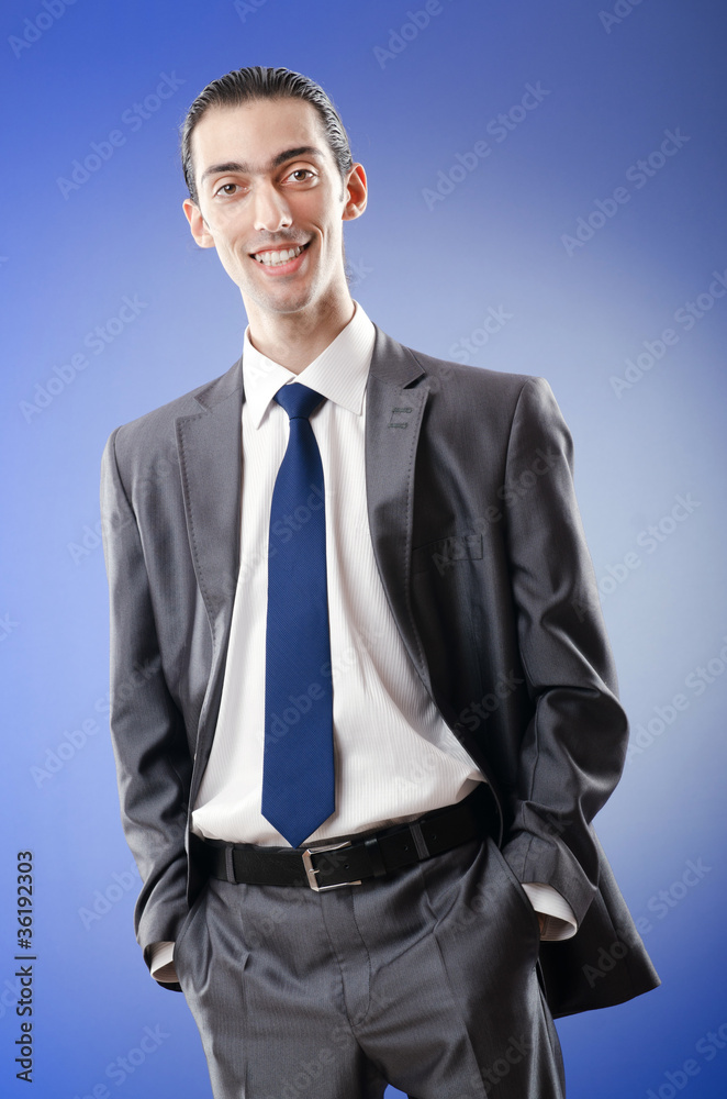 Fototapeta premium Young businessman in studio shooting