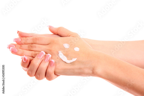 Closeup of beautiful female hands applying hand cream