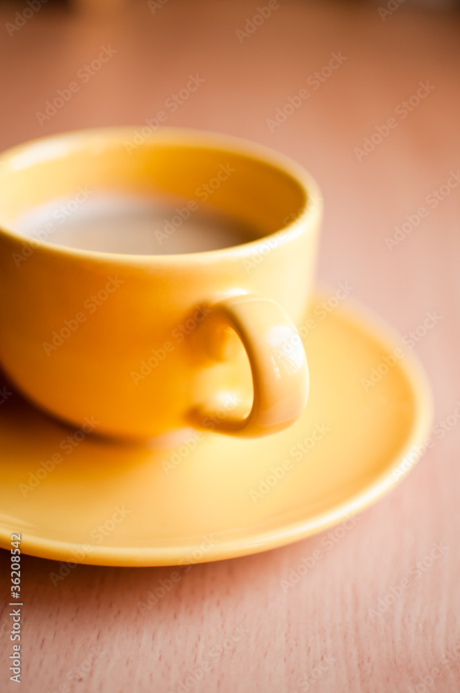 Fototapeta premium Coffee in an yellow cup