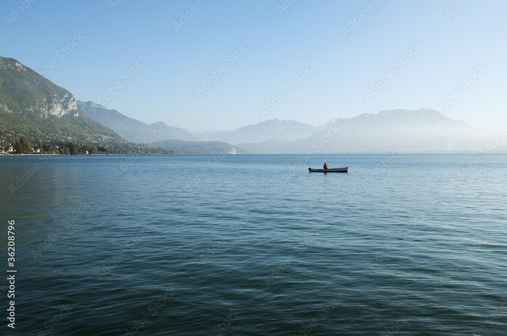 Fisherman on his boat on lake Annecy