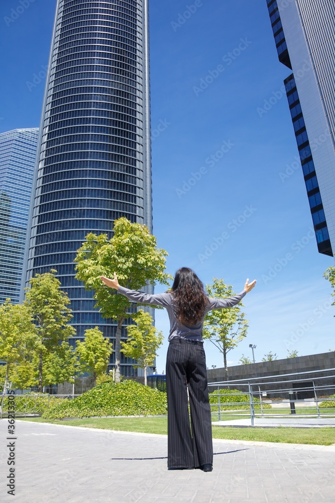 business woman greeting skyscrapers business woman greeting skyscrapers