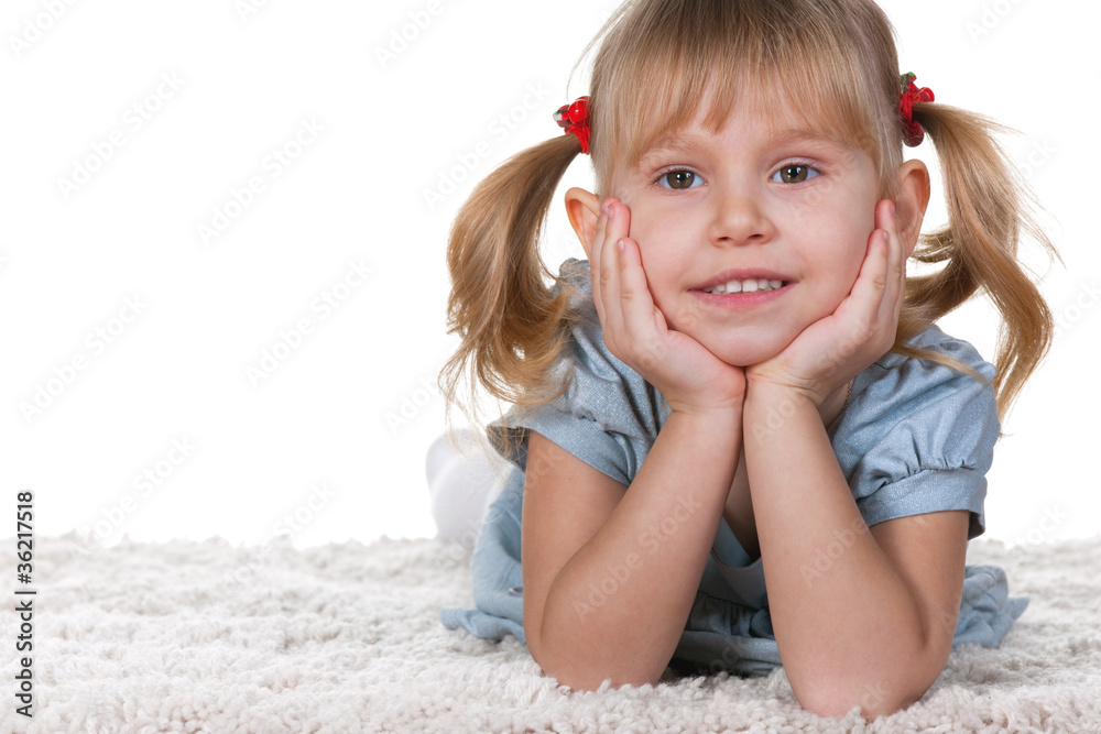 Smiling little girl lying on the carpet Smiling little girl lying on the carpet