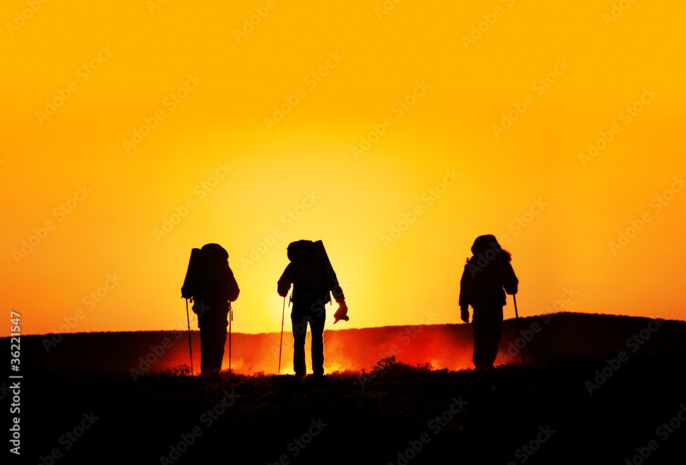 tourist silhouettes at sunset