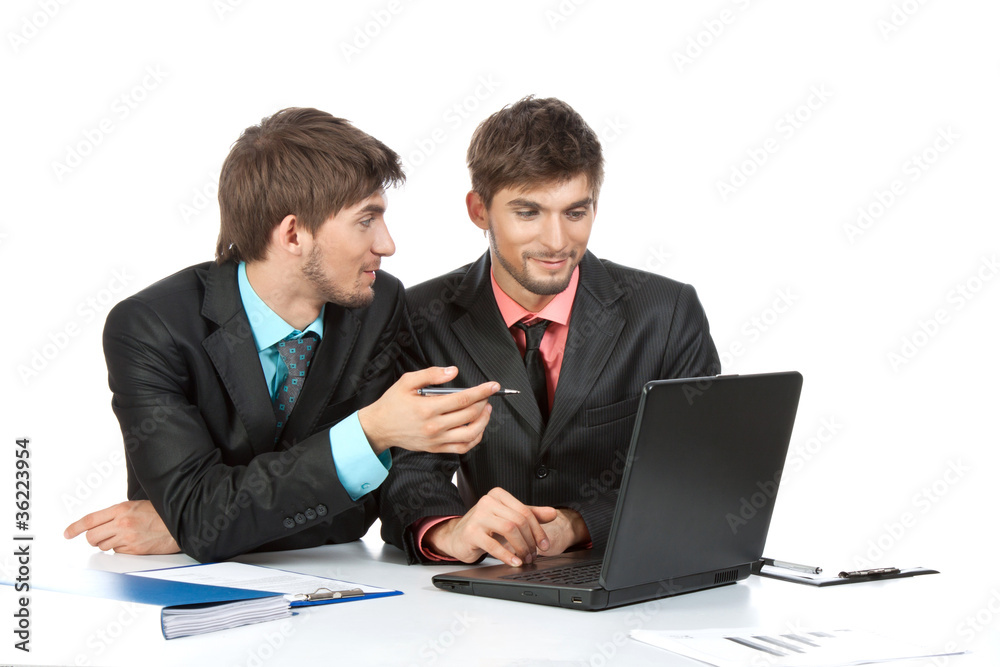 Two business people in elegant suits sitting at desk working Two business people in elegant suits sitting at desk working