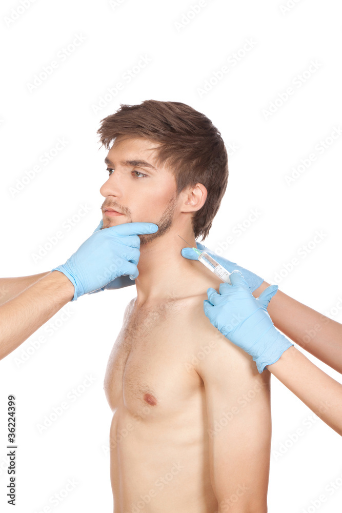 hands in blue gloves hold attractive young male face hands in blue gloves hold attractive young male face