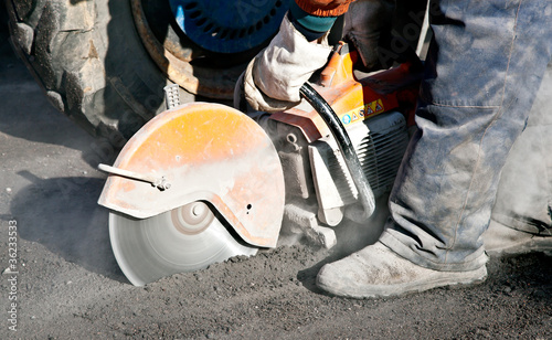 Cutting road works with petrol driven angle grinder