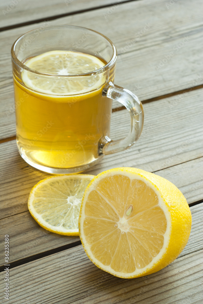 cup of tea and lemon on wooden table cup of tea and lemon on wooden table