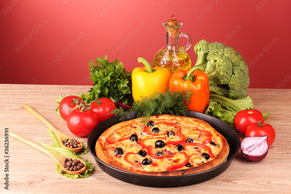 pizza and vegetables on a red background pizza and vegetables on a red background