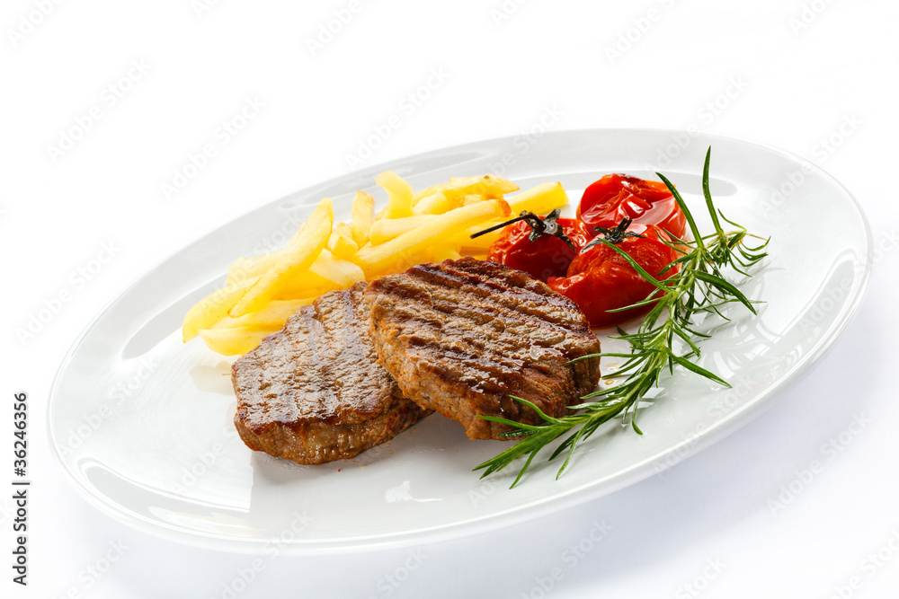 Grilled steak, French fries and vegetables Grilled steak, French fries and vegetables