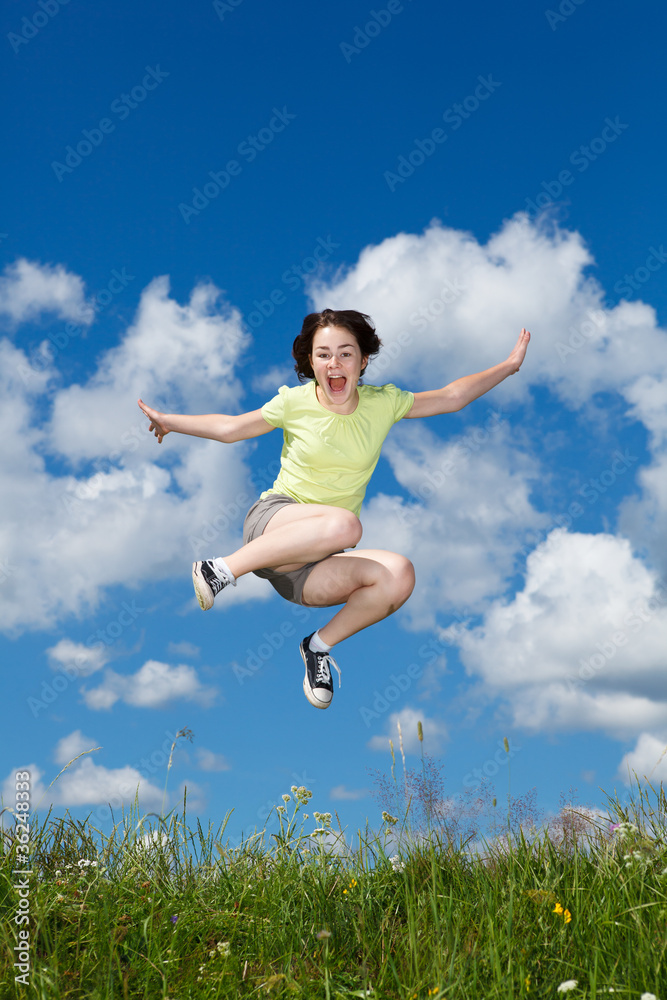 Girl jumping, running against blue sky Girl jumping, running against blue sky