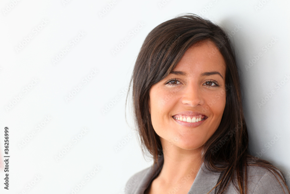 Beautiful businesswoman standing on grey background Beautiful businesswoman standing on grey background