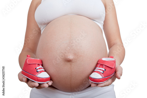 Wallpaper Mural Pregnant woman hold in hand red baby boots Torontodigital.ca