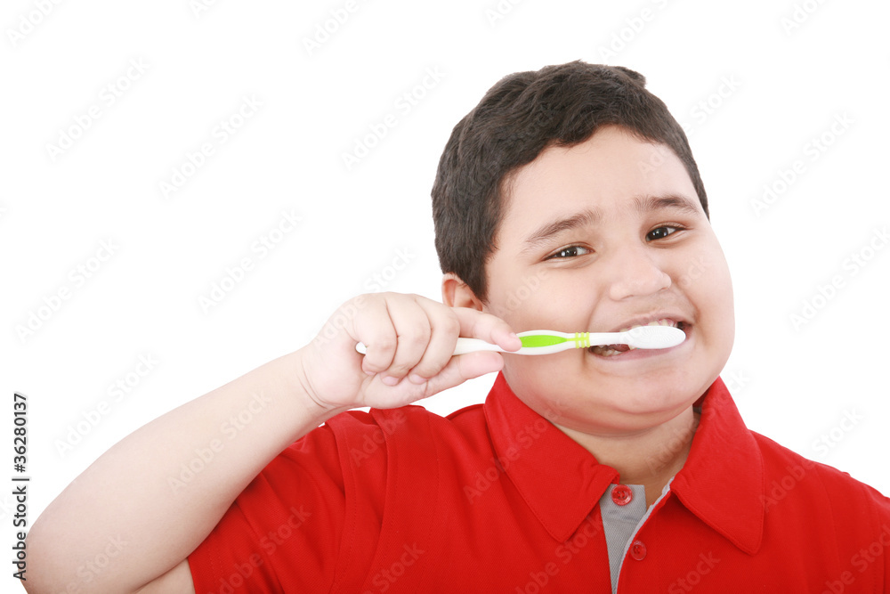 Beautiful boy brushing teeth, isolated on white Beautiful boy brushing teeth, isolated on white