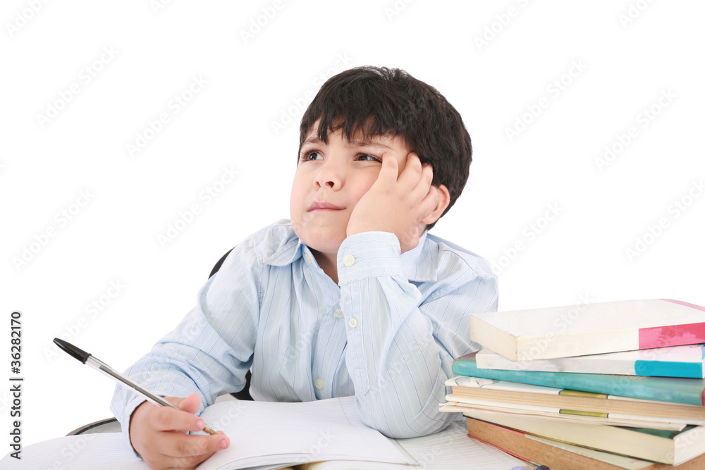 Upset schoolboy doing homework isolated on white Upset schoolboy doing homework isolated on white