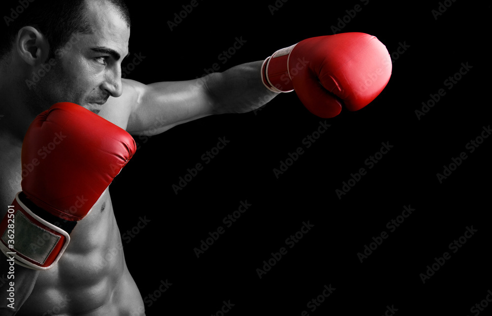 Young Boxer fighter over black background
