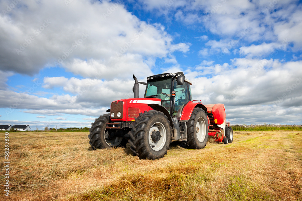 tractor collecting haystack in the field, panning technique tractor collecting haystack in the field, panning technique