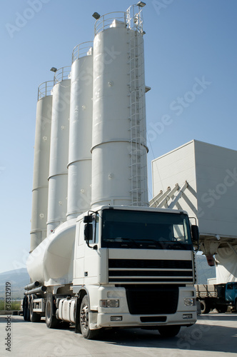 Cement factory with silos and mixer truck photo