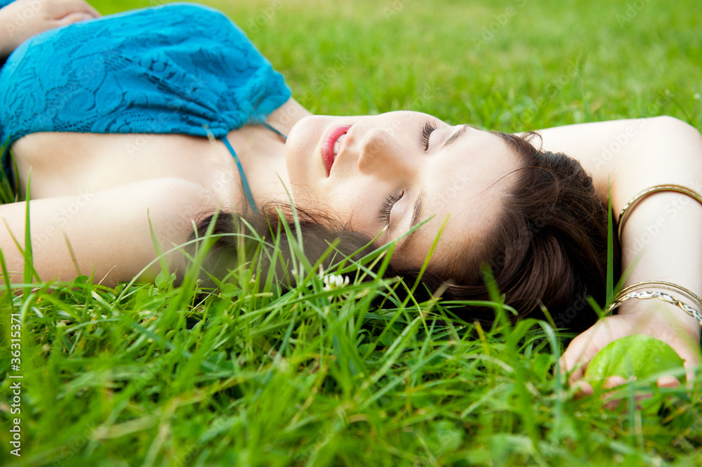 Pretty brunette girl wearing elegant dress relaxing outdoor in g Pretty brunette girl wearing elegant dress relaxing outdoor in g
