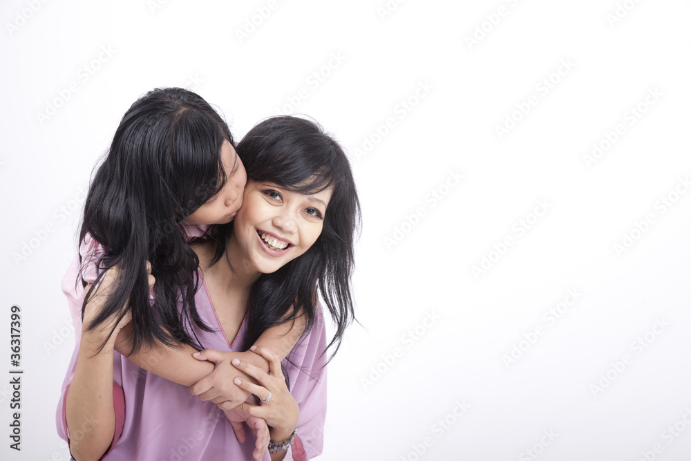 Daughter gives her mum a kiss Daughter gives her mum a kiss